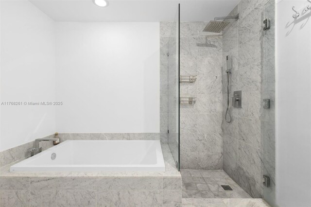 bathroom with a bath and a shower stall