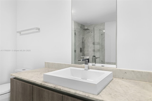 full bathroom featuring toilet, vanity, and a shower stall