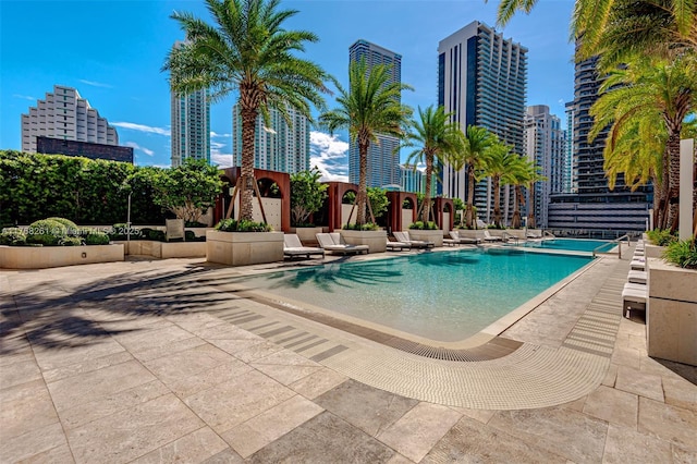 pool featuring a patio and a city view
