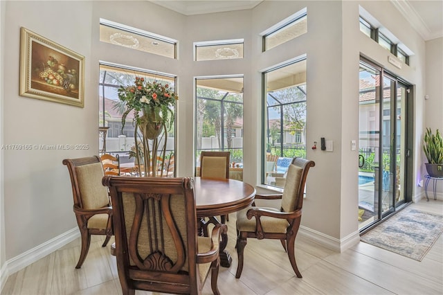 11812 S Cantal Cir S, Parkland, FL 33076 - dining room with healthy amount of natural light, baseboards, ornamental molding, a sunroom, and a towering ceiling