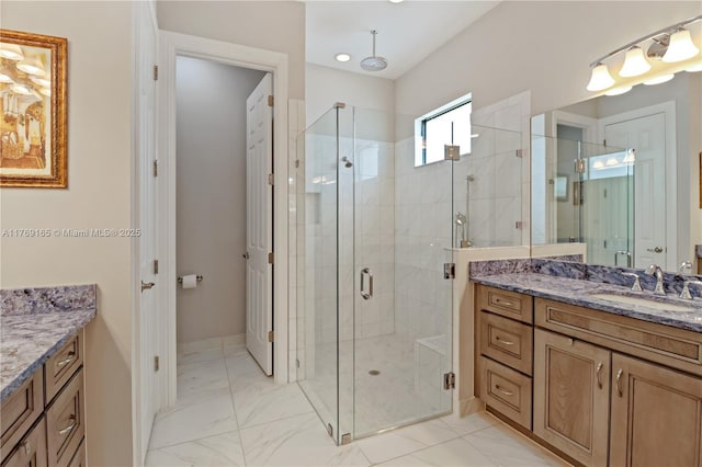full bathroom with marble finish floor, vanity, and a stall shower