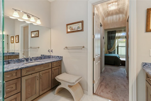 ensuite bathroom featuring baseboards, ensuite bath, vanity, and crown molding