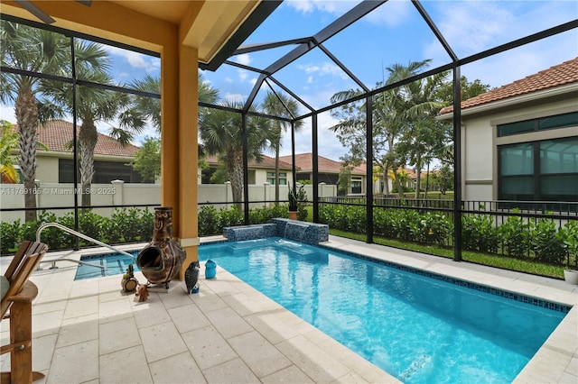 view of pool featuring a patio area, a fenced backyard, a fenced in pool, and glass enclosure