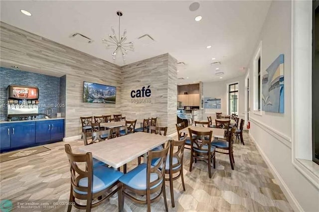 dining space with recessed lighting, baseboards, and a notable chandelier
