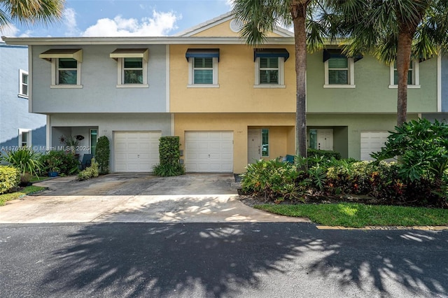1747 NE 4th Ave Unit F2, Fort Lauderdale, FL 33305 - view of front of property featuring an attached garage, driveway, and stucco siding