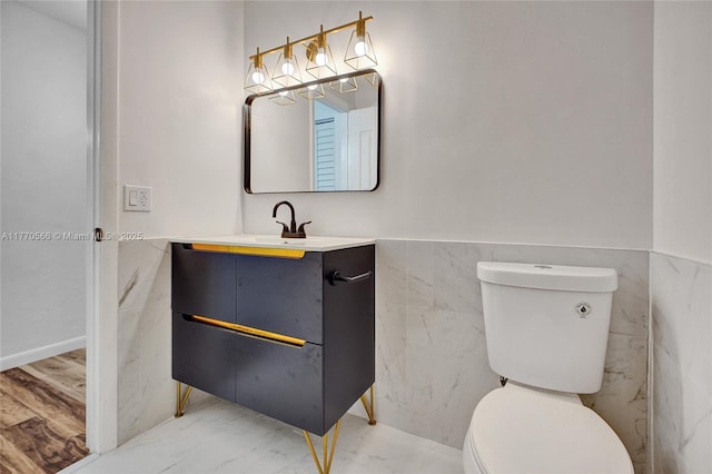 2030 Bayberry Dr Unit 2030, Pembroke Pines, FL 33024 - half bathroom with toilet, vanity, tile walls, and wainscoting