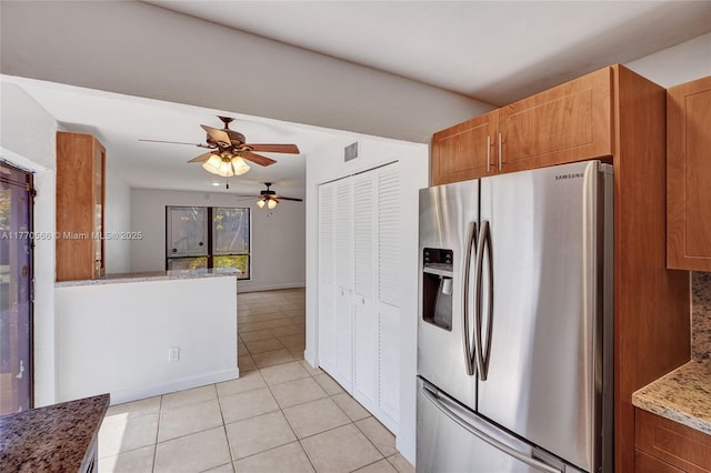 2030 Bayberry Dr Unit 2030, Pembroke Pines, FL 33024 - kitchen with stainless steel fridge with ice dispenser, a ceiling fan, light tile patterned floors, brown cabinets, and light stone countertops