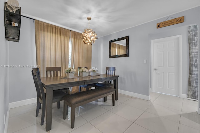 dining space featuring an inviting chandelier, baseboards, and light tile patterned floors