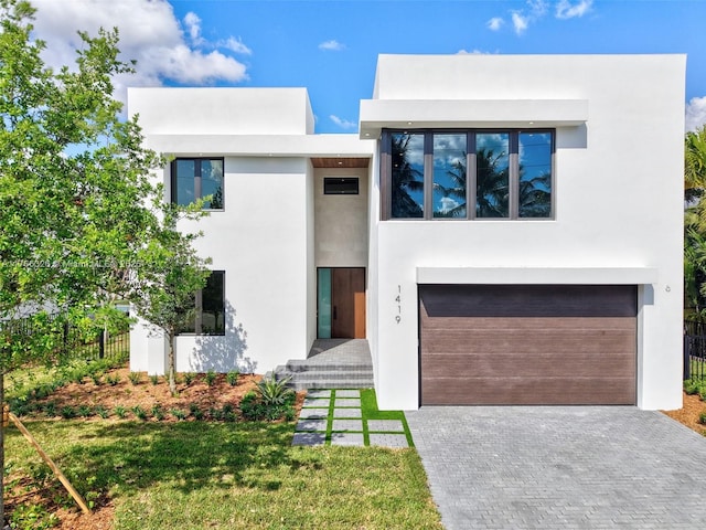 1419 N Lakeside Dr, Lake Worth, FL 33460 - contemporary house with an attached garage, stucco siding, and driveway