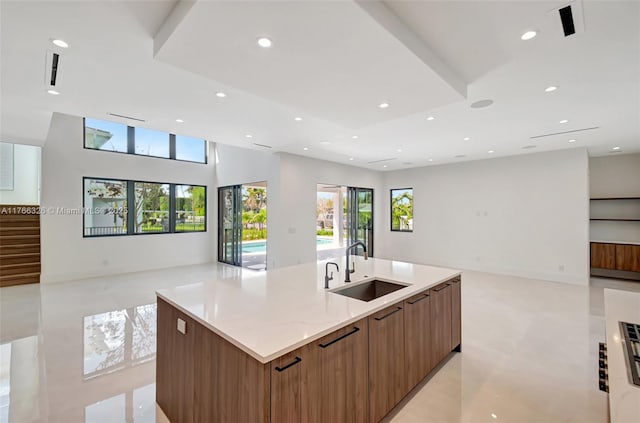1419 N Lakeside Dr, Lake Worth, FL 33460 - kitchen featuring open floor plan, a sink, modern cabinets, a center island with sink, and healthy amount of natural light