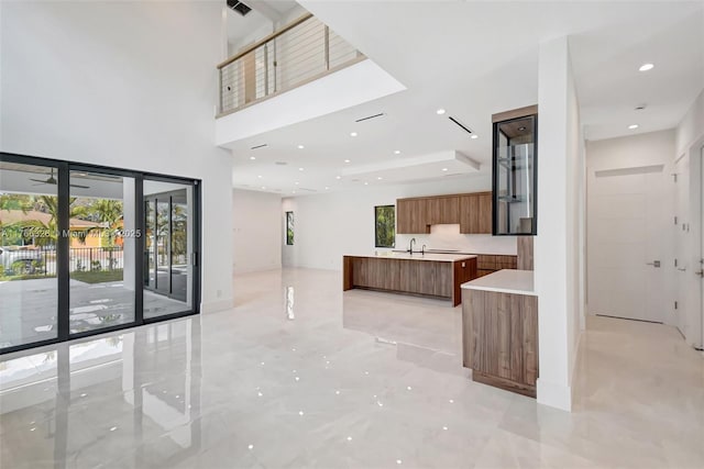 1419 N Lakeside Dr, Lake Worth, FL 33460 - kitchen with modern cabinets, brown cabinetry, healthy amount of natural light, light countertops, and recessed lighting