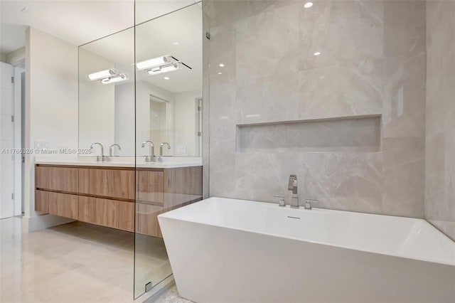 1419 N Lakeside Dr, Lake Worth, FL 33460 - bathroom with a soaking tub, double vanity, and tile walls