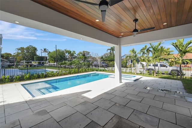 1419 N Lakeside Dr, Lake Worth, FL 33460 - view of swimming pool featuring a ceiling fan, a fenced backyard, a patio, and a pool with connected hot tub