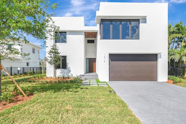 1419 N Lakeside Dr, Lake Worth, FL 33460 - modern home featuring stucco siding, driveway, and an attached garage