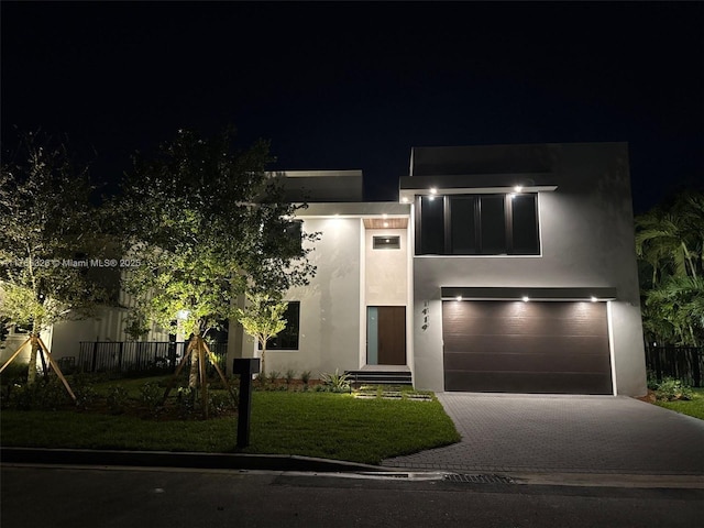 1419 N Lakeside Dr, Lake Worth, FL 33460 - modern home featuring a garage, driveway, and stucco siding