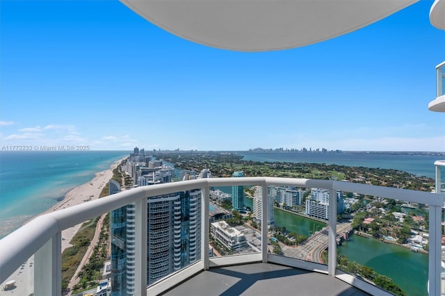 balcony with a water view and a view of city
