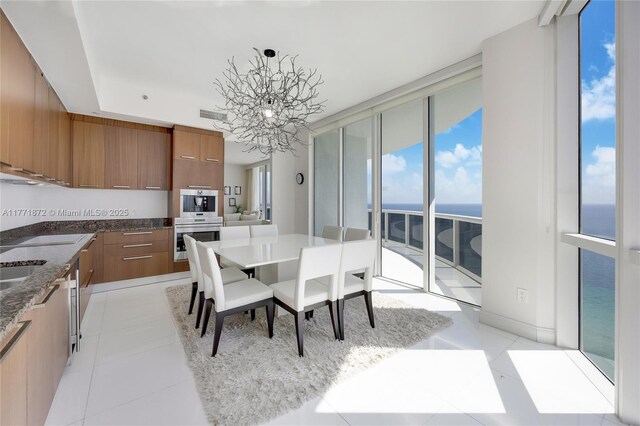 15811 Collins Ave Unit 2101, Sunny Isles Beach, FL 33160 - dining room featuring a chandelier and a water view