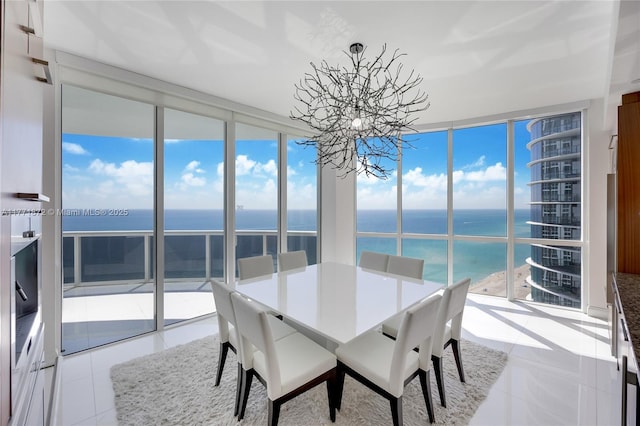15811 Collins Ave Unit 2101, Sunny Isles Beach, FL 33160 - dining room featuring a chandelier, a water view, and light tile patterned flooring