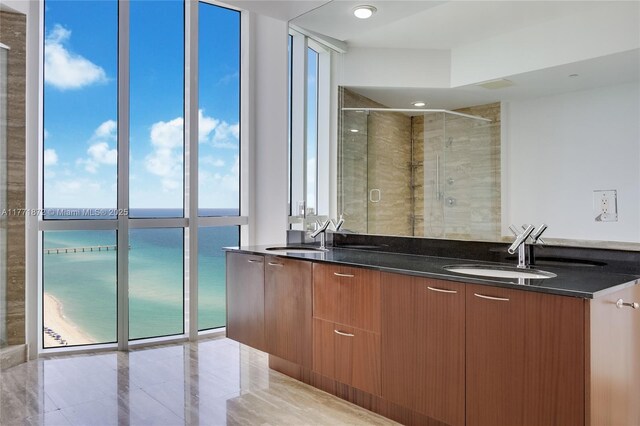 15811 Collins Ave Unit 2101, Sunny Isles Beach, FL 33160 - bathroom featuring double vanity, a stall shower, and a water view