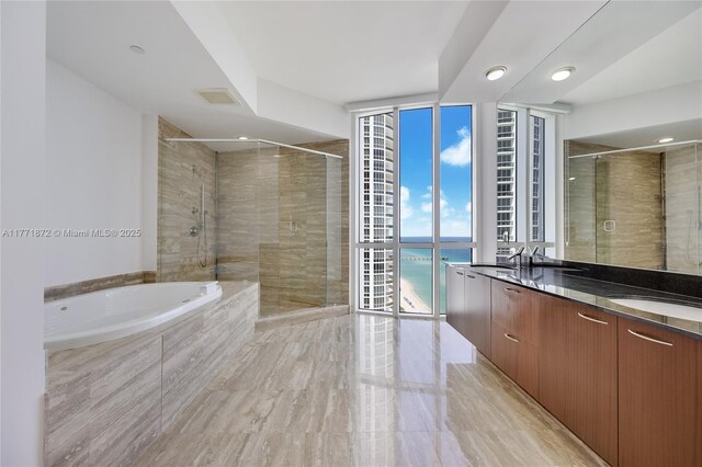15811 Collins Ave Unit 2101, Sunny Isles Beach, FL 33160 - full bathroom with double vanity, a bath, a water view, a shower stall, and floor to ceiling windows