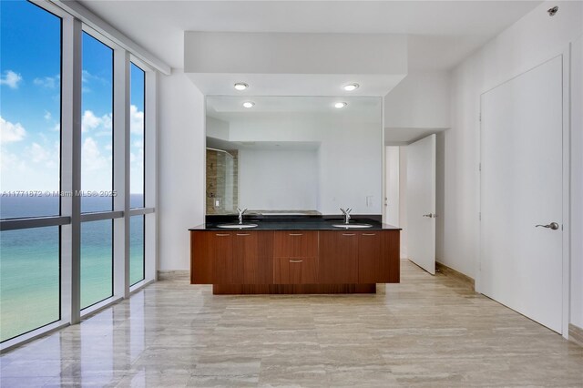 15811 Collins Ave Unit 2101, Sunny Isles Beach, FL 33160 - bathroom featuring healthy amount of natural light, double vanity, a water view, and recessed lighting
