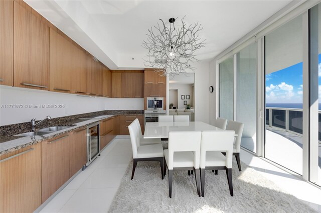 15811 Collins Ave Unit 2101, Sunny Isles Beach, FL 33160 - dining space featuring wine cooler, plenty of natural light, a chandelier, and light tile patterned floors