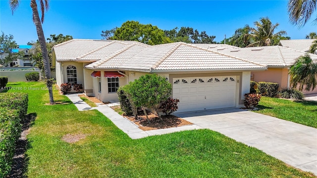 4738 Dundee Dr, Bradenton, FL 34210 - view of front of home with a tiled roof, a front lawn, stucco siding, an attached garage, and driveway