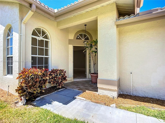 4738 Dundee Dr, Bradenton, FL 34210 - view of exterior entry with stucco siding and a tiled roof