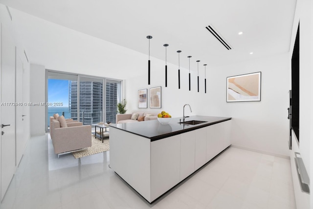 300 Biscayne Blvd Way Unit 4206W, Miami, FL 33131 - kitchen with a sink, white cabinetry, modern cabinets, dark countertops, and a peninsula