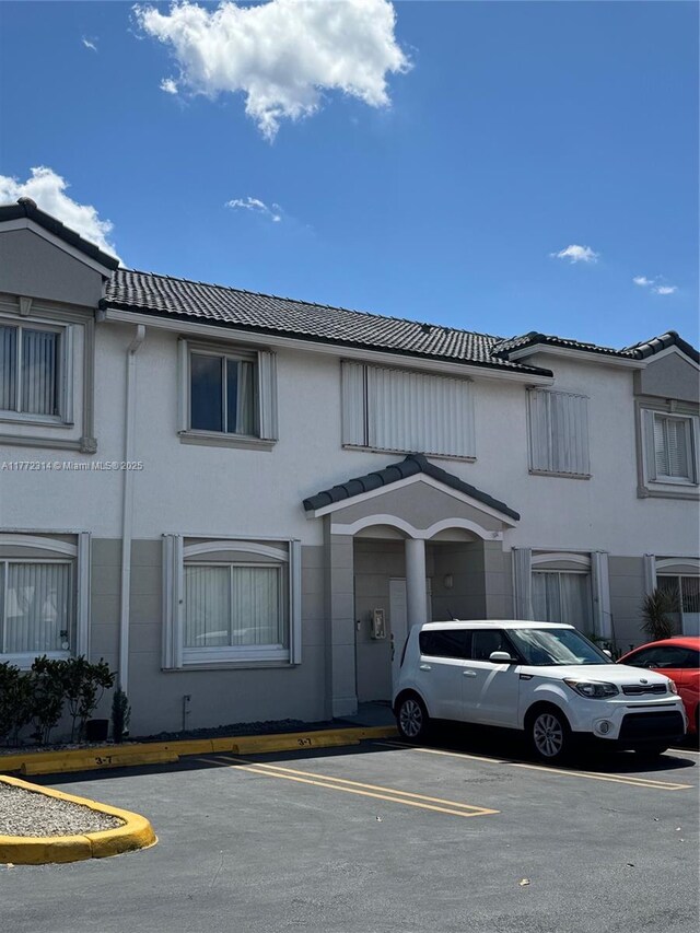 130 SW 109th Ave Unit 7, Sweetwater, FL 33174 - townhome / multi-family property featuring uncovered parking, a tiled roof, and stucco siding