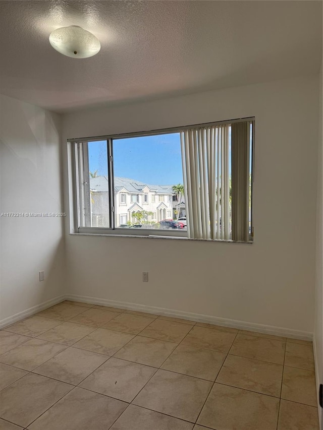 130 SW 109th Ave Unit 7, Sweetwater, FL 33174 - unfurnished room featuring baseboards, a textured ceiling, and light tile patterned floors
