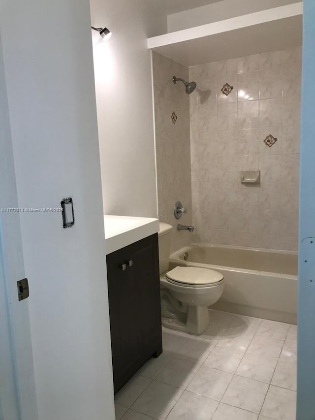 bathroom with vanity, tile patterned flooring, toilet, and  shower combination