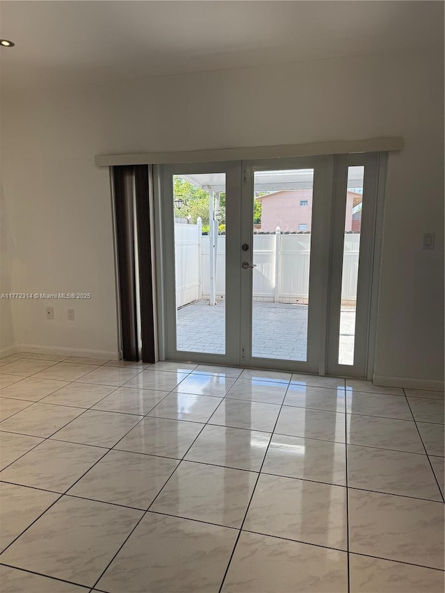 130 SW 109th Ave Unit 7, Sweetwater, FL 33174 - spare room with french doors, baseboards, and light tile patterned flooring