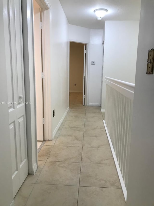hallway featuring light tile patterned floors