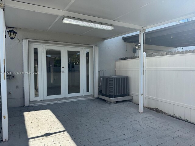 130 SW 109th Ave Unit 7, Sweetwater, FL 33174 - view of patio featuring french doors, central AC unit, and fence