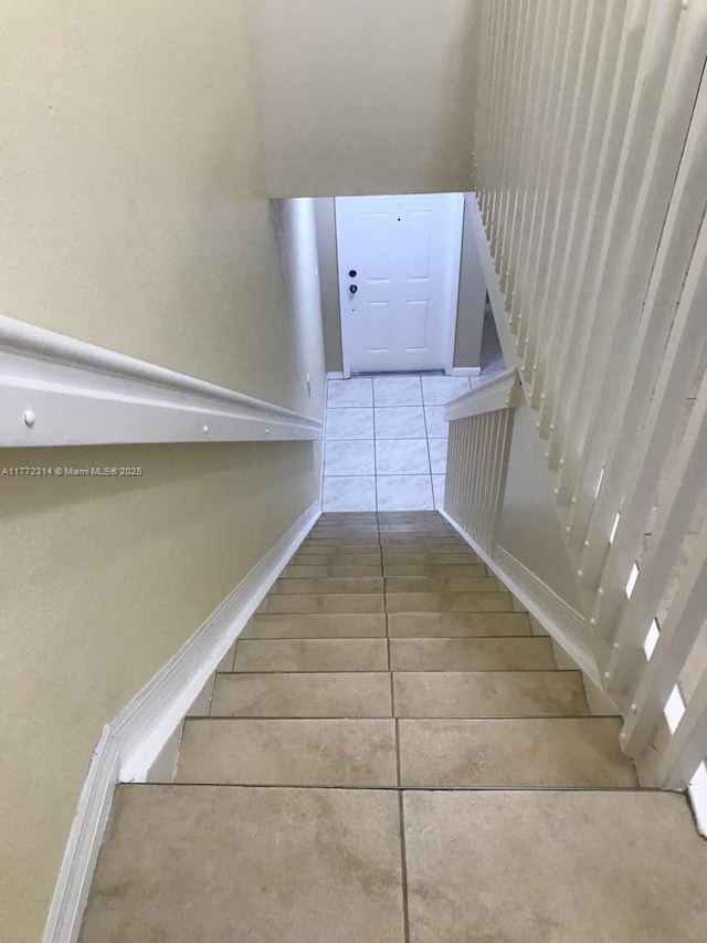 stairway with tile patterned flooring