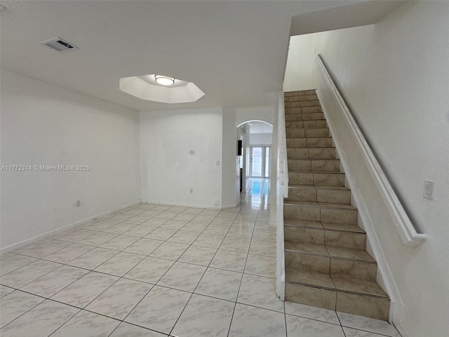 130 SW 109th Ave Unit 7, Sweetwater, FL 33174 - staircase with arched walkways, tile patterned flooring, and baseboards