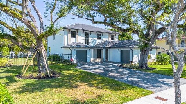 7285 SW 72nd Ter, Miami, FL 33143 - traditional home with driveway, an attached garage, and stucco siding