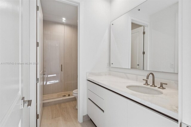 7285 SW 72nd Ter, Miami, FL 33143 - bathroom with vanity, toilet, wood finished floors, recessed lighting, and a stall shower