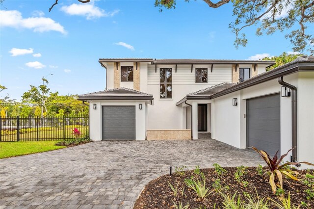 7285 SW 72nd Ter, Miami, FL 33143 - view of front of home featuring stucco siding, decorative driveway, a tile roof, and an attached garage