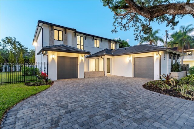 7285 SW 72nd Ter, Miami, FL 33143 - view of front of house featuring a garage, decorative driveway, stucco siding, and a tiled roof