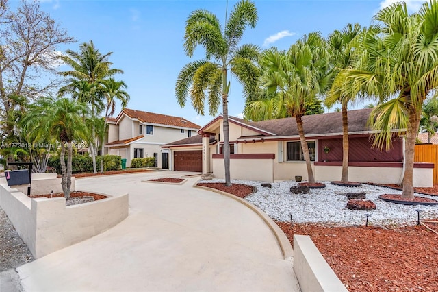 view of front of house featuring an attached garage, concrete driveway, and stucco siding