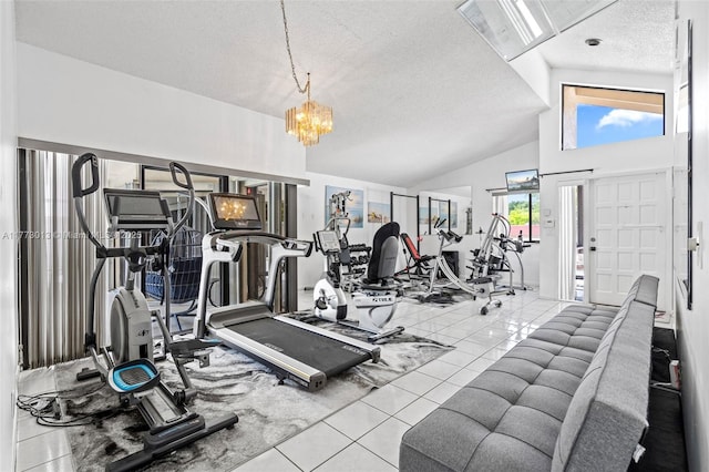 gym featuring an inviting chandelier, a textured ceiling, tile patterned floors, and vaulted ceiling