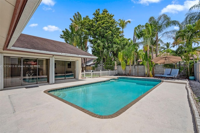 view of swimming pool featuring a fenced in pool, a fenced backyard, and a patio area