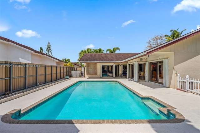 view of swimming pool with a fenced backyard, a fenced in pool, and a patio area