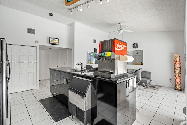 kitchen with visible vents, ceiling fan, high vaulted ceiling, a sink, and light tile patterned floors