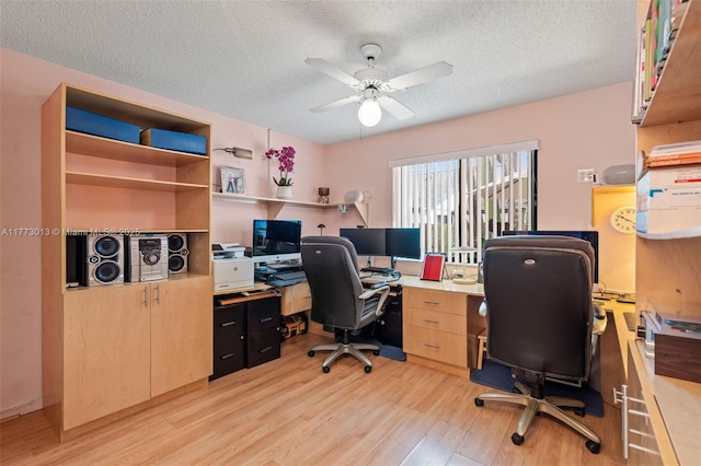 office with a ceiling fan, a textured ceiling, and light wood-type flooring
