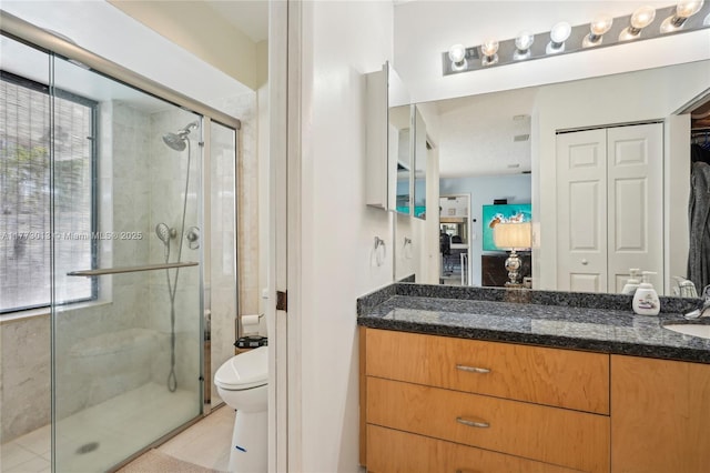 full bathroom with vanity, toilet, tile patterned floors, and a stall shower