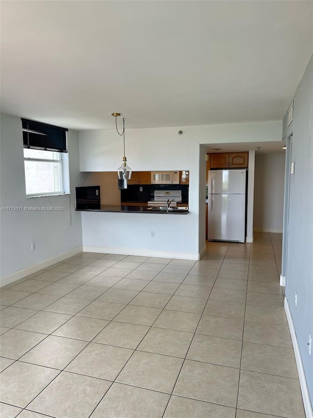 2400 SW 3rd Ave Unit 605, Miami, FL 33129 - unfurnished living room featuring baseboards, a sink, and light tile patterned floors