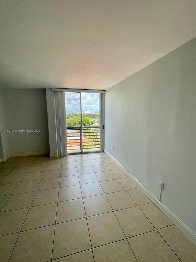 2400 SW 3rd Ave Unit 605, Miami, FL 33129 - unfurnished room featuring floor to ceiling windows, light tile patterned floors, and baseboards